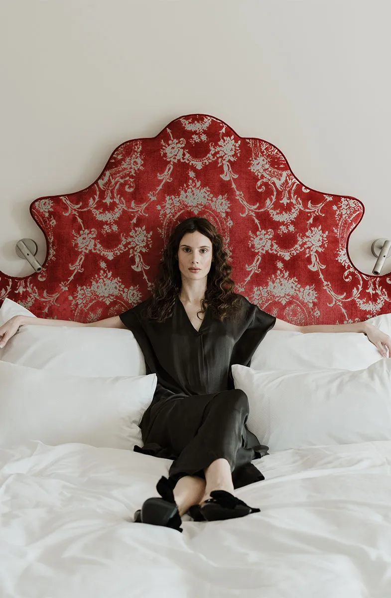 Woman relaxing in bed in a room of Grand Elisabeth Hotel Bad Ischl