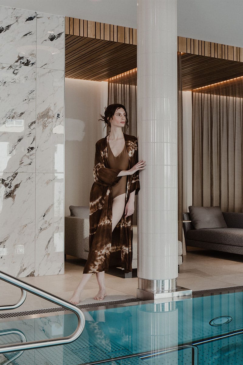 Frau im Bademantel am Pool im Wellnessbereich des Grand Elisabeth Hotels