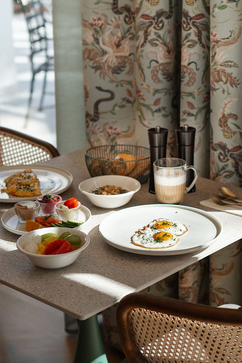Frühstück im Grand Liberté in Bad Ischl mit Spiegelei, Obst und Müsli am gedeckten Tisch