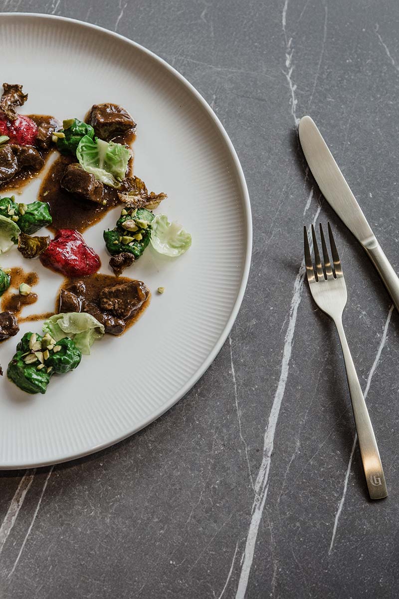 Gourmet dish served at Grande Liberté Bad Ischl on white plate